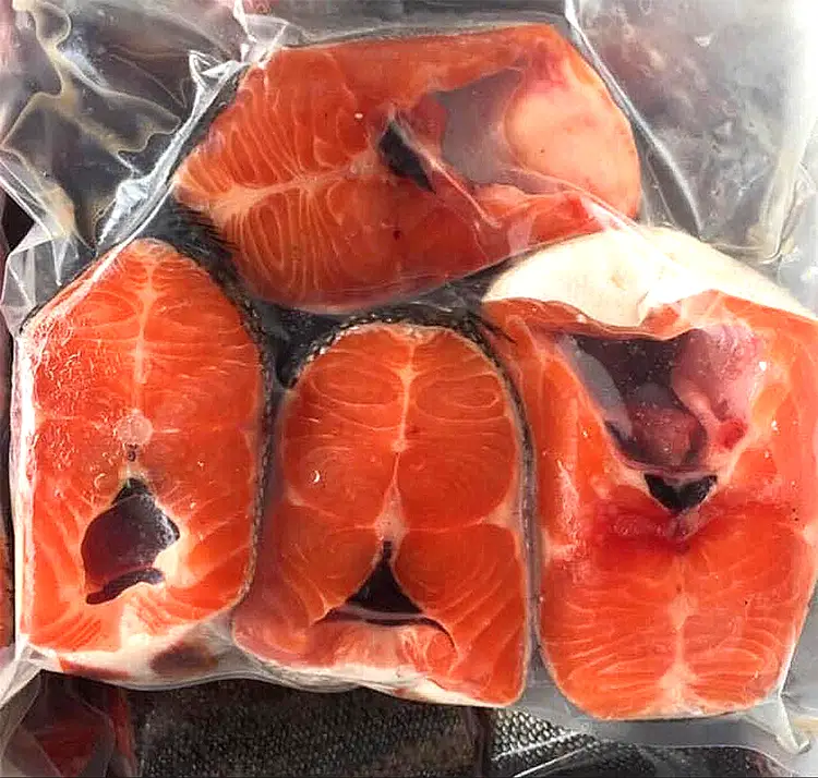 Store the raw salmon in the coldest part of your fridge